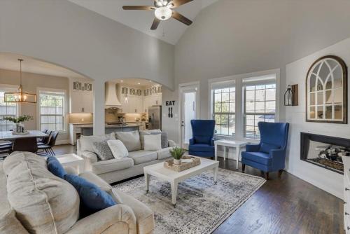 a living room with a couch and blue chairs at Texan Sunny Oasis 5 BED Private Pool Hot tub in Rowlett