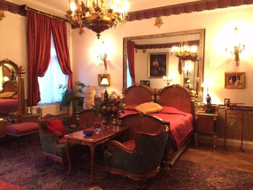 a bedroom with a bed and a table and a mirror at Imre Guest House in Budapest