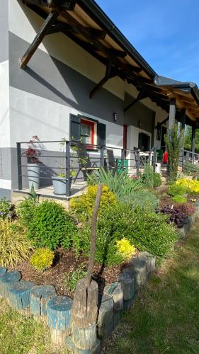 a garden in front of a house with a statue at Goričko view house in Križevci