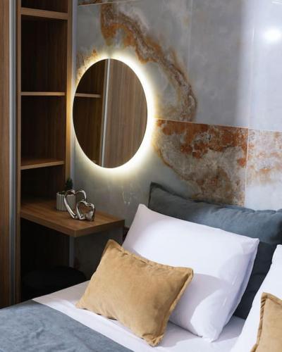 a bedroom with a bed with a mirror on the wall at Blue Apartment in the Hill in Moírai