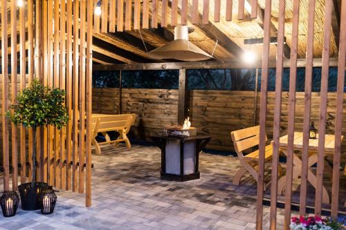 a patio with a table and chairs in a room at Beskid Loft House - domki w górach in Sól