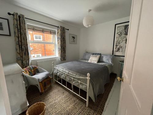 a small bedroom with a bed and a window at No 28 cosy cottage in the heart of Cowes in Cowes