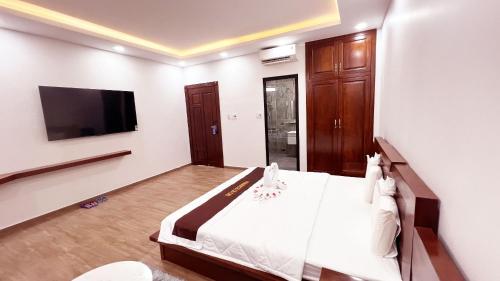 a bedroom with a bed and a flat screen tv at Paradise Cu Chi Hotel in Củ Chi