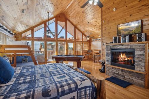 a living room with a bed and a fireplace at A Piece of Heaven is a Wonderful Dog-Friendly 2 Bedroom Cabin in Starr Crest Resort! in Sevierville