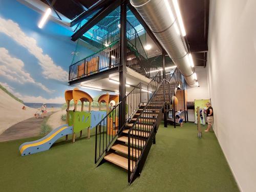 a building with a playground with a slide at Kompas Camping Nieuwpoort in Nieuwpoort