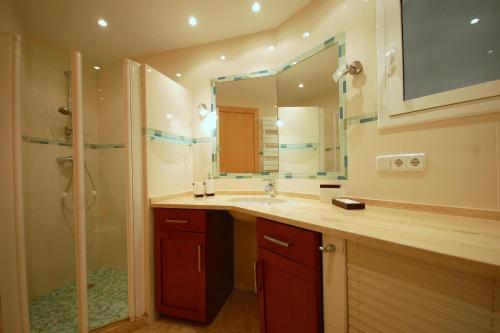 a bathroom with a sink and a shower and a mirror at LETS HOLIDAYS SEA VIEWS APARTMENT & POOL in SA GABARRA in Tossa de Mar