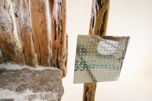 a metal object is hanging on a wall at B&B Domos Mi & Ro in Castelsardo
