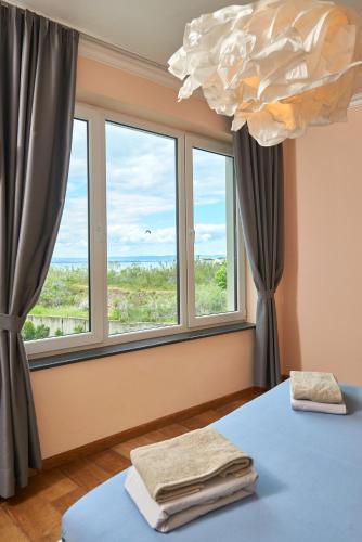 a room with a bed and a large window at Luxury Sea View Apartment in Pomorie in Pomorie