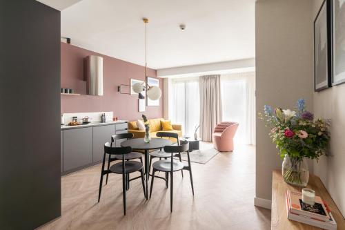 a kitchen and living room with a table and chairs at YAYS Antwerp Opera by Numa in Antwerp