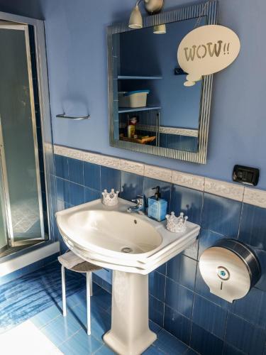 a bathroom with a white sink and a mirror at Umberto 25 in Santo Stefano di Camastra