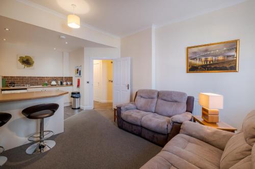 a living room with a couch and a table at Spacious 2-Bedroom Condo With Free Parking On Site in Montrose