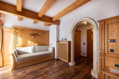 a living room with a couch and an archway at Hotel Stalon Alpine Chic in San Martino di Castrozza