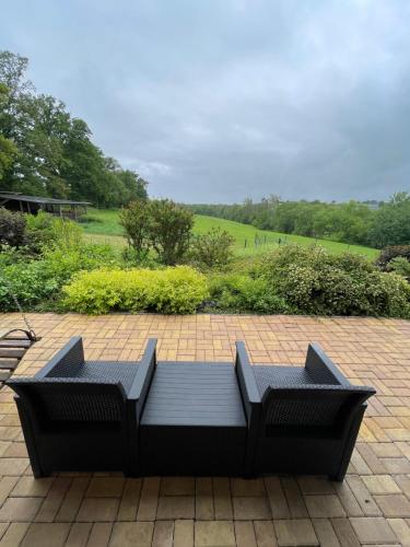 a black bench sitting on a brick patio at Dolpo 5 in Benešov
