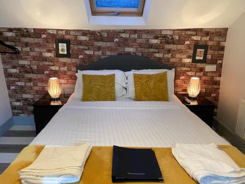 a bedroom with a large bed with two lamps at Ivy Mount Boutique in Manchester