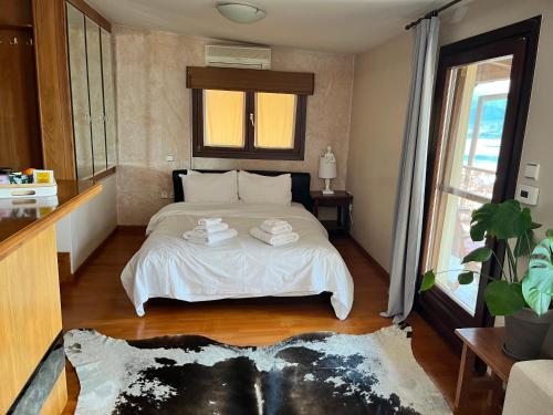 1 dormitorio con 1 cama con 2 toallas en sunlight loft en Kastoria