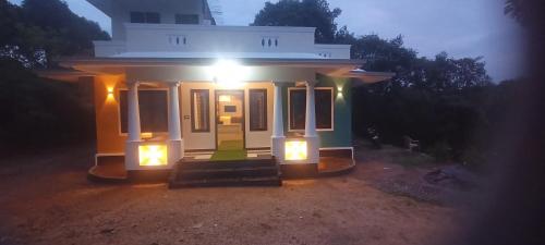 a small house with a light on it at night at Alpine aura in Vagamon