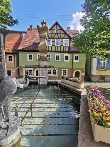 a water fountain in front of a building at Panoramablick in Langenburg