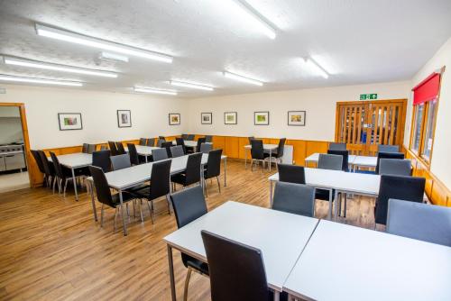a classroom with tables and chairs in a room at Aviemore Youth Hostel in Aviemore