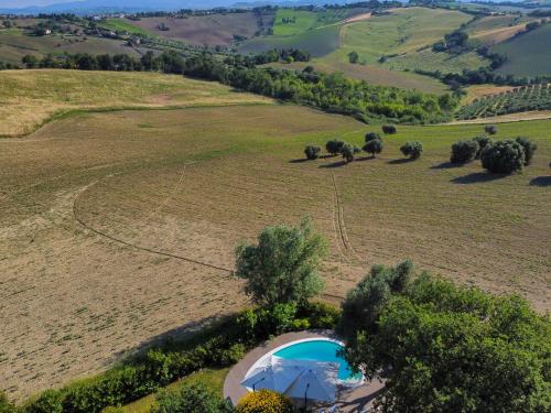 an aerial view of a farm with a tent in a field at Casali Marchigiani - Ville vacanza private con piscina in Ostra