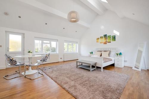 a living room with a white couch and a table at Country Chalet New Forest in Hordle