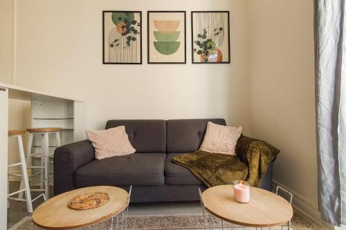 un salon avec un canapé et deux tables dans l'établissement Cozy apartment near the sea, à Nice