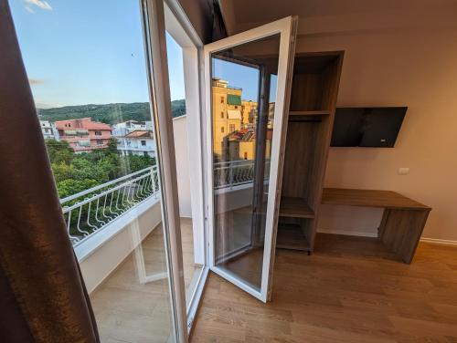 a mirror in a room with a balcony at Villa with Garden & Balcony in Berat