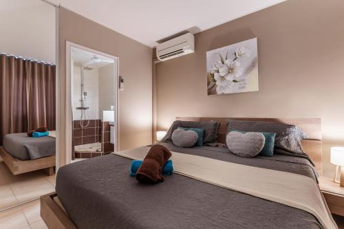 a bedroom with a large bed and a bathroom at Vue imprenable sur le lagon, appartement 1ch 4p in Baie Nettle