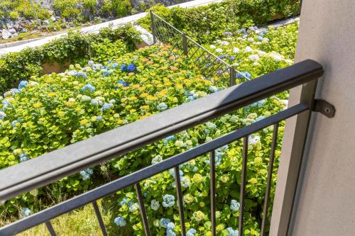a balcony with a garden of flowers at Portopiccolo Apartments in Sistiana