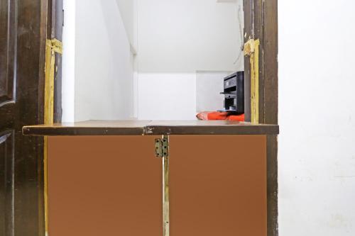 a wooden shelf in a room with a table at Hotel Sun Residency By The Premium Villa in New Delhi