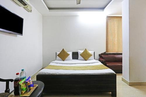 a bedroom with a bed and a tv in a room at Hotel Premium Room Near Hazrat Nizamuddin railway station in New Delhi