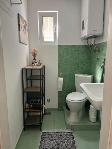 a bathroom with a white toilet and a sink at Sailors Home Stari Bar in Bar