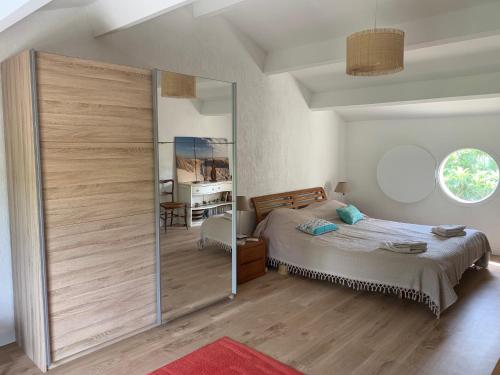 a bedroom with a bed and a sliding glass door at Villa 4 Etoiles Climatisée, Piscine, Parking in Saint-Cyr-sur-Mer