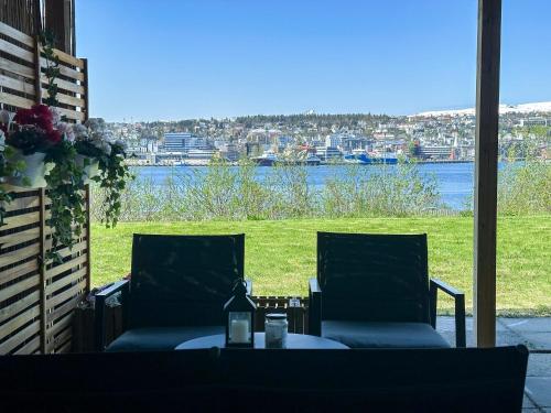 a patio with two chairs and a table with a view at Panorama View - FREE Parking - PERFECT For Couples in Tromsø