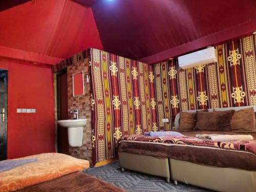 a room with a bed and a sink in it at Shakria Bedouin Life Camp in Wadi Rum