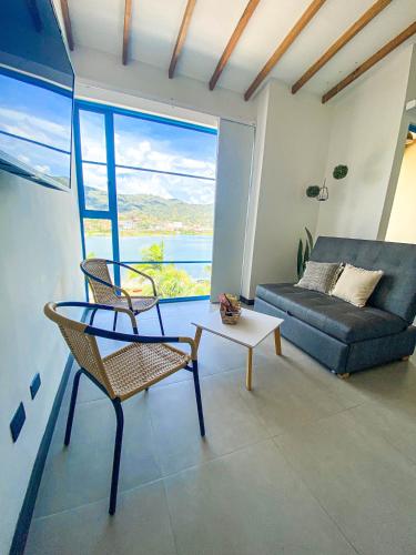 a living room with a couch and a table at Casa García Rent Home in Guatapé