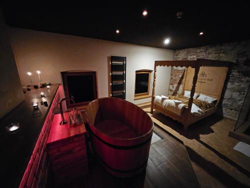 a room with a bar with a couch and a bed at LH Hotel Dvořák Tábor Congress & Wellness in Tábor