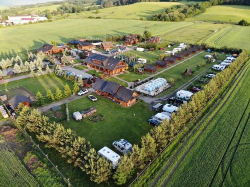 an aerial view of a large house with a lot of cars at Ubytovanie Koliba Pacho - Zrub Anicka in Prievidza