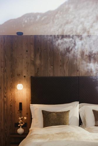 a bedroom with a bed with a wooden head board at Luxury Chalet Milé in Ortisei