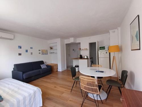 Cette chambre comprend un lit, une table et un canapé. dans l'établissement Studio lumineux, à Marseille