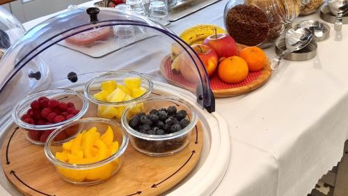 a bunch of bowls of fruit on a counter at Boutique B&B Número Cuatro in Benissa