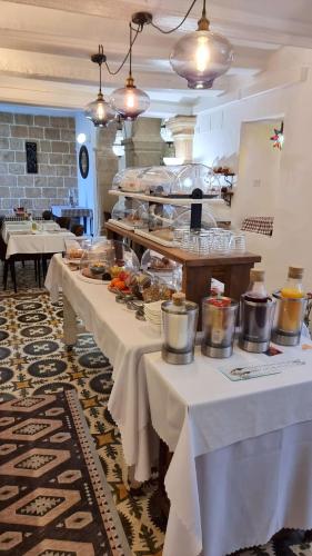 a restaurant with two tables with food on them at Boutique B&B Número Cuatro in Benissa