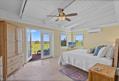 a bedroom with a bed and a ceiling fan at Sunset Vista Beach House in Pensacola Beach