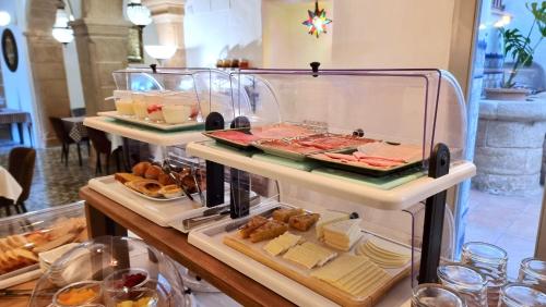 a display case filled with different types of food at Boutique B&B Número Cuatro in Benissa