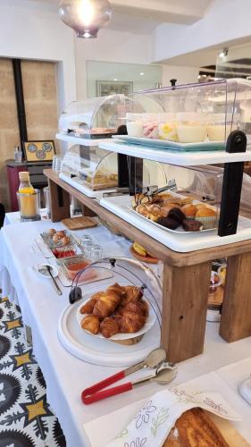 a buffet line with plates of pastries and other food at Boutique B&B Número Cuatro in Benissa