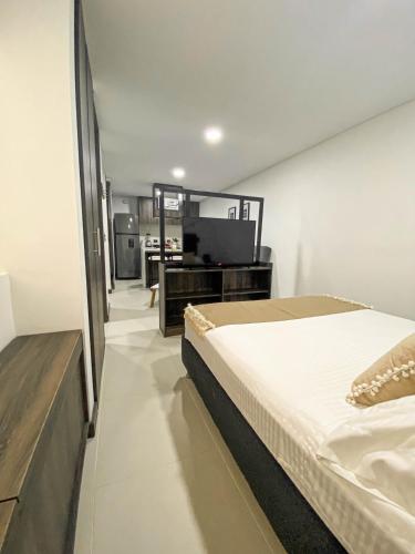 a bedroom with a bed and a desk and a television at Casa García Rent Home in Guatapé