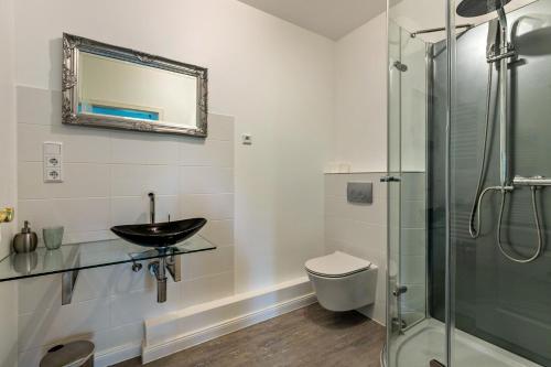 a bathroom with a sink and a glass shower at Sylt in Galmsbüll