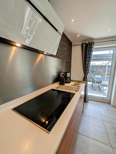a kitchen with a stove top oven in a kitchen at La Chataigneraie in Châtenois