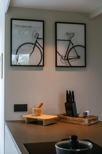 two framed pictures of a bike hanging on a wall at Huswell - Holiday home along the canal with great views in Damme