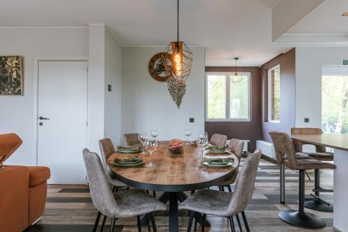 a dining room with a table and chairs at Huswell - Holiday home along the canal with great views in Damme