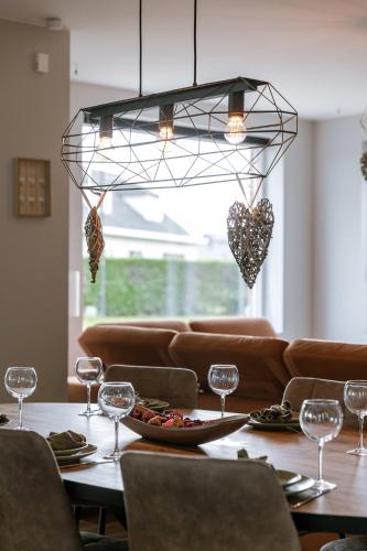 a dining room with a table with wine glasses at Huswell - Holiday home along the canal with great views in Damme